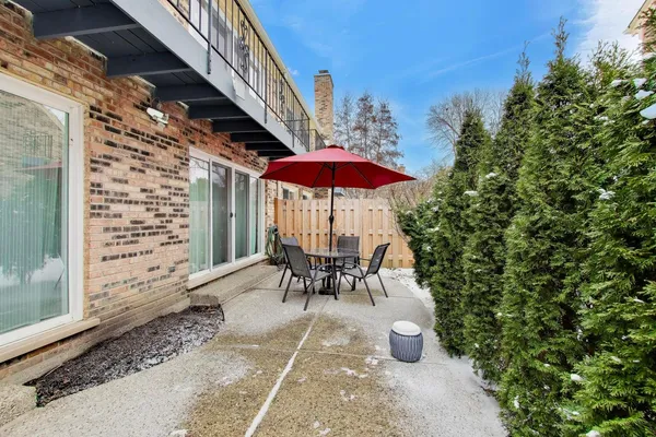 a view of a chair and table in the patio