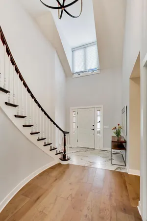 a view of entryway and hall with wooden floor