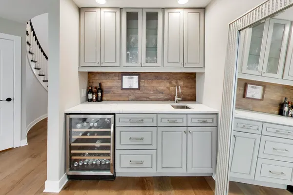 a kitchen with white cabinets and sink