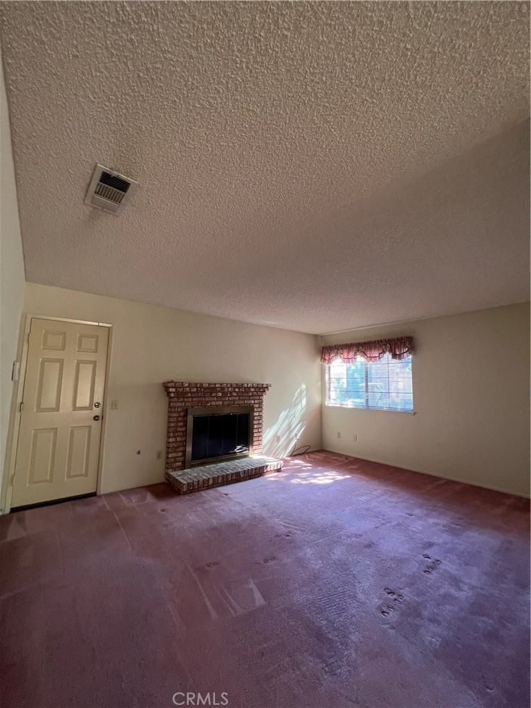 5650 Los Robles La Verne, CA 91750 - Photo 8 of 20 an empty room with a fireplace and window