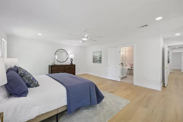 a bedroom with a bed and a mirror