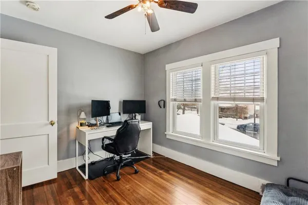 a view of a workspace with furniture and a window