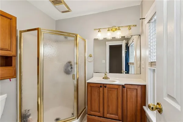a bathroom with a shower sink and mirror