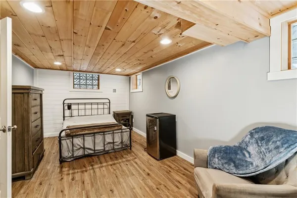 a bedroom with furniture and wooden floor