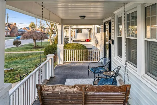 a view of a porch with chairs and backyard