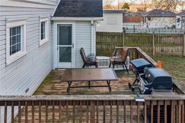 a roof deck with table and chairs