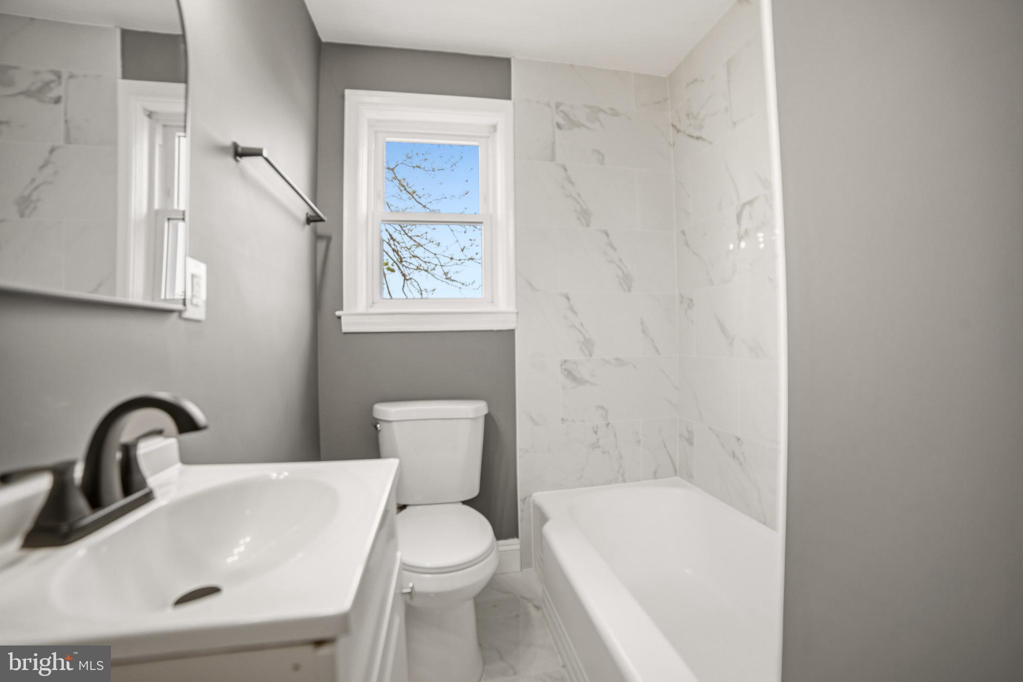 4434 Manorview Road Baltimore, MD 21229 - Photo 12 of 34 a bathroom with a sink and a bathtub