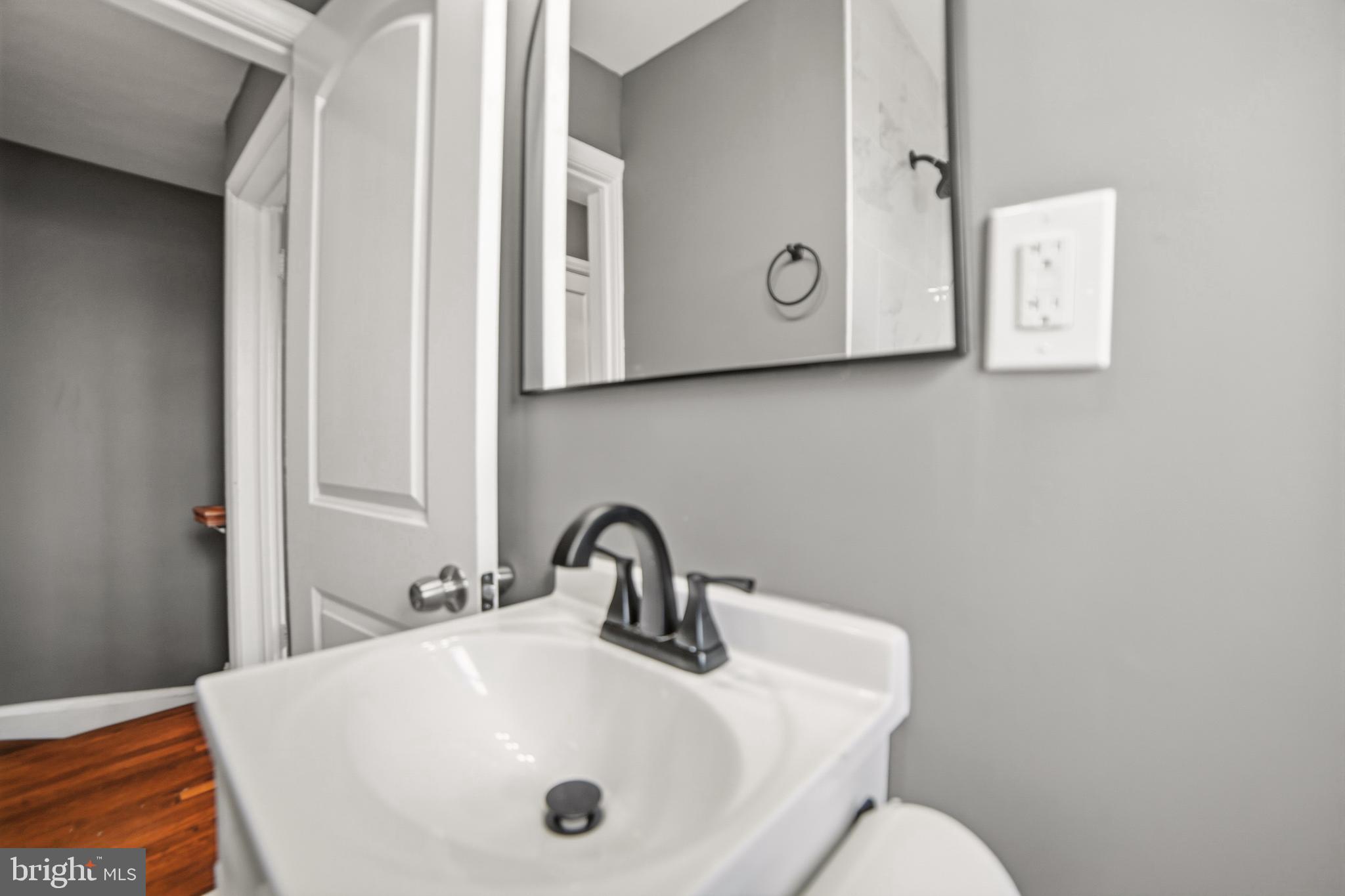 4434 Manorview Road Baltimore, MD 21229 - Photo 13 of 34 a bathroom with a sink and mirror