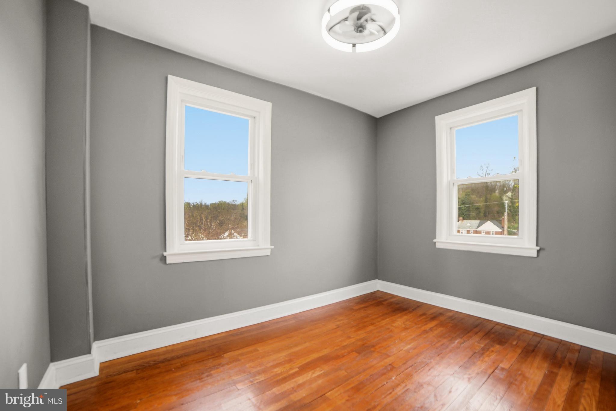 4434 Manorview Road Baltimore, MD 21229 - Photo 14 of 34 a view of an empty room with wooden floor and a window