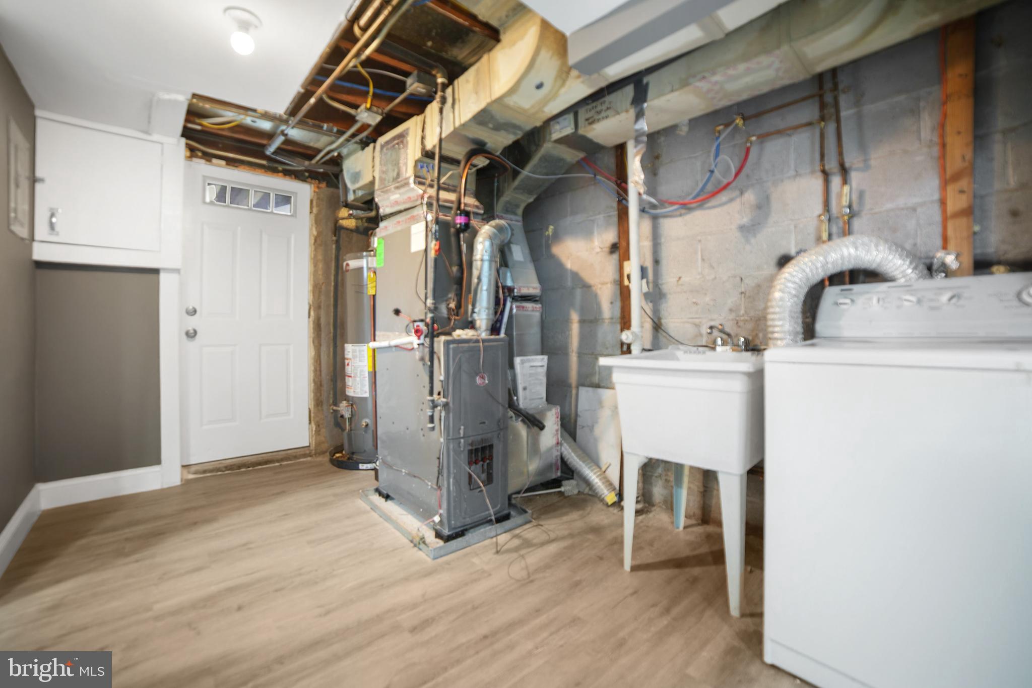 4434 Manorview Road Baltimore, MD 21229 - Photo 28 of 34 a view of a storage & utility room with washer and dryer