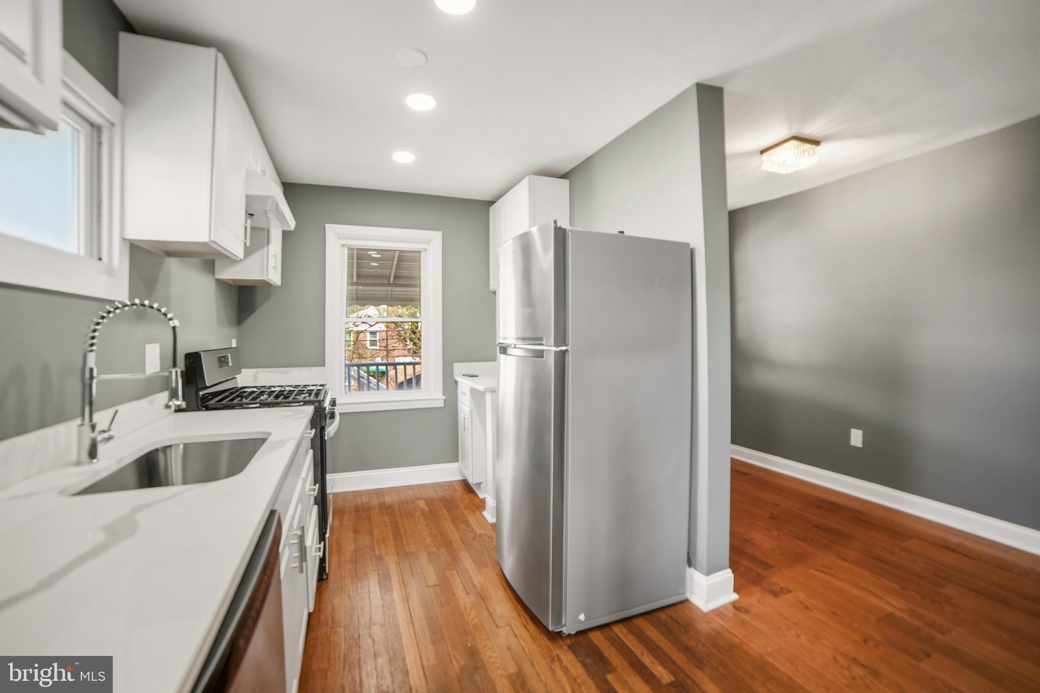 4434 Manorview Road Baltimore, MD 21229 - Photo 5 of 34 a kitchen with a refrigerator sink and cabinets