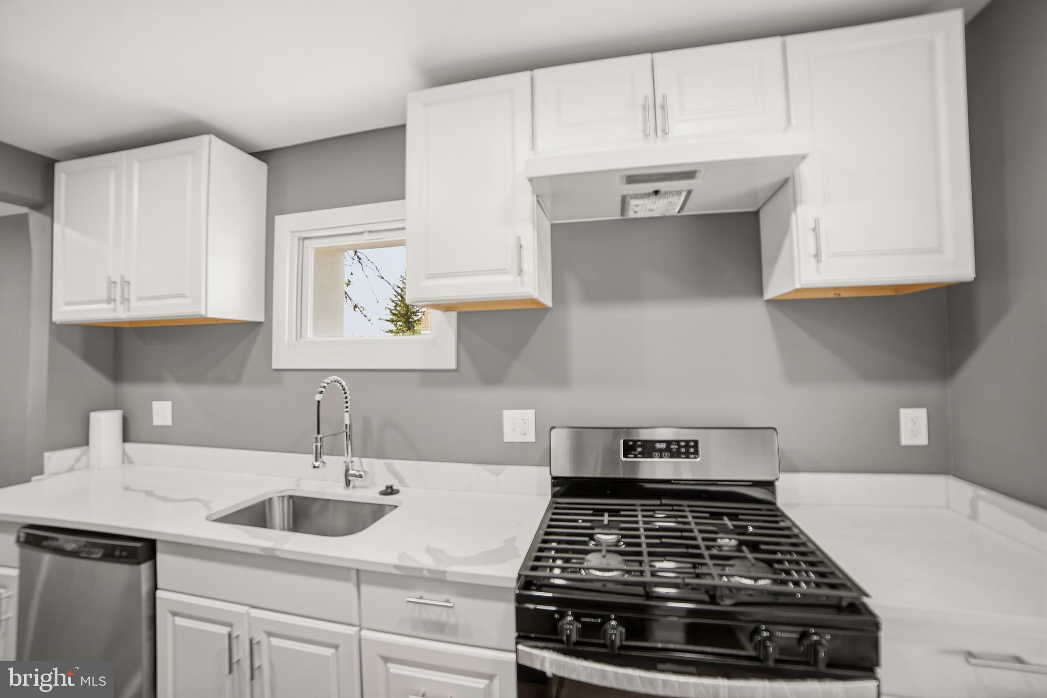 4434 Manorview Road Baltimore, MD 21229 - Photo 6 of 34 a kitchen with granite countertop white cabinets and a stove