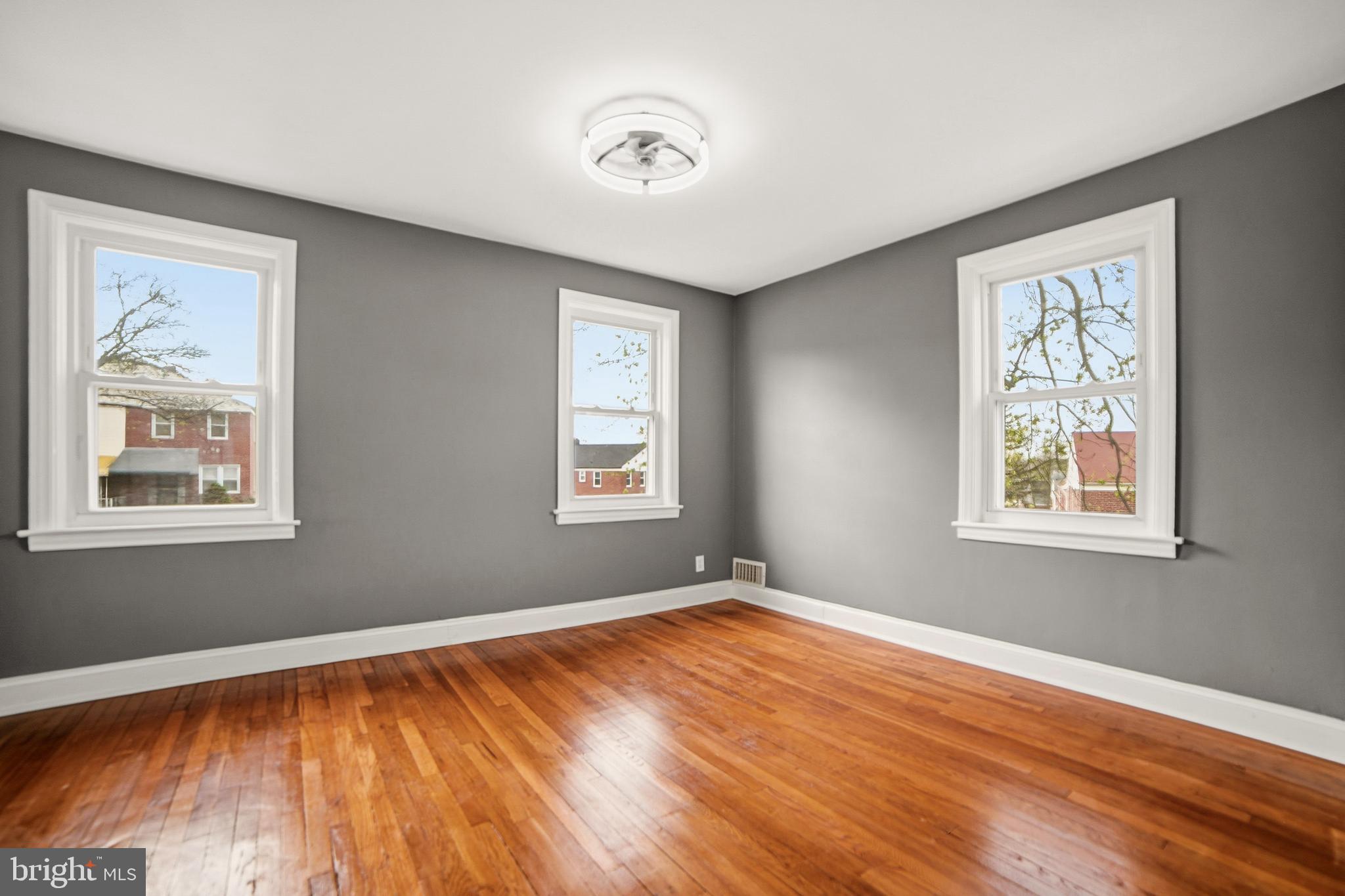 4434 Manorview Road Baltimore, MD 21229 - Photo 8 of 34 a view of empty room with wooden floor and fan