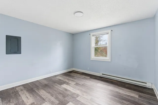 a view of a room with wooden floor and window