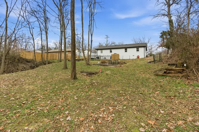 a view of a big yard with wooden fence