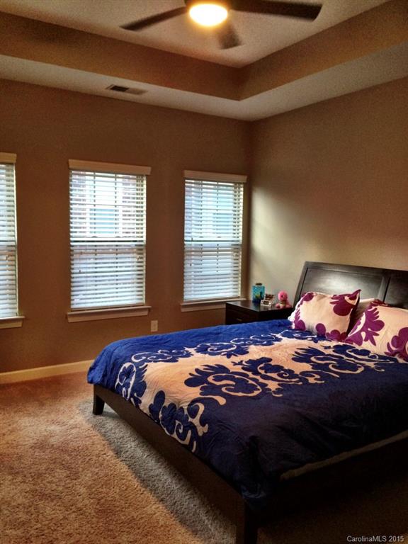 14713 Intermilan Way Charlotte, NC 28277 - Photo 12 of 16 a bedroom with a bed and lamp