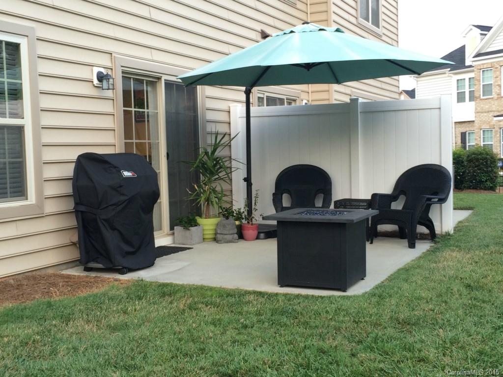 14713 Intermilan Way Charlotte, NC 28277 - Photo 16 of 16 a view of a chairs and table in the back yard of the house