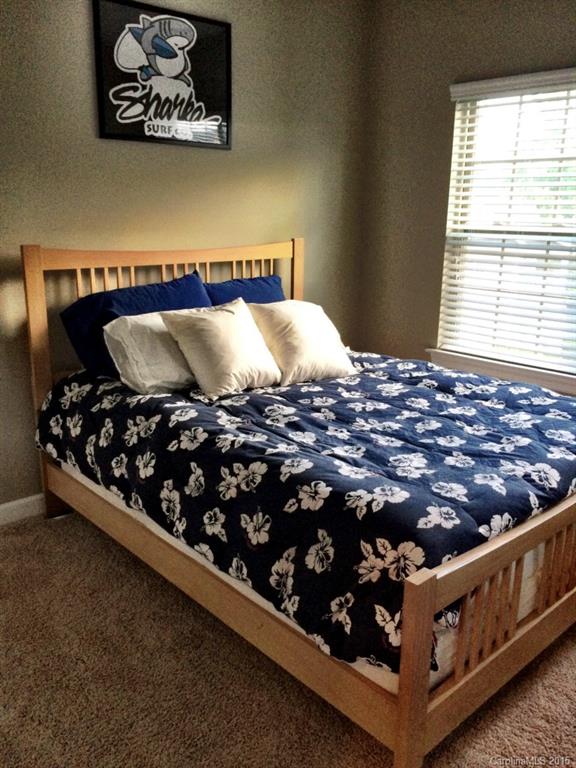 14713 Intermilan Way Charlotte, NC 28277 - Photo 10 of 16 a bed sitting in a bedroom next to a window