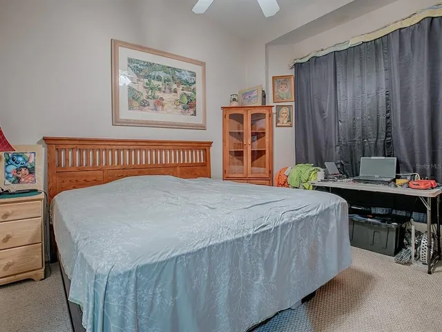 a bedroom with a bed and a table in it