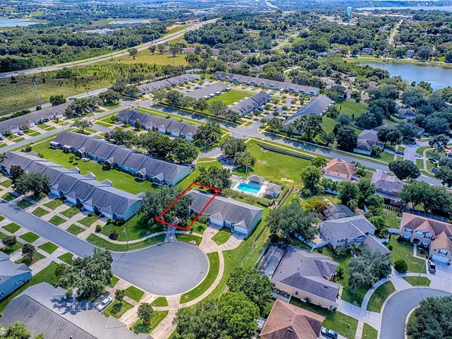 an aerial view of residential building and lake