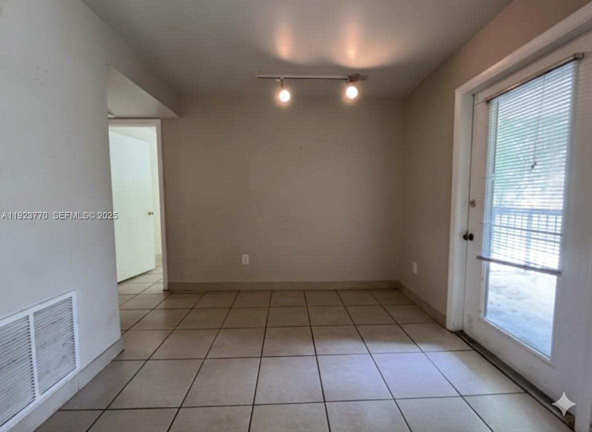 4201 West McNab Road, Unit 15 Pompano Beach, FL 33069 - Photo 13 of 18 an empty room with windows