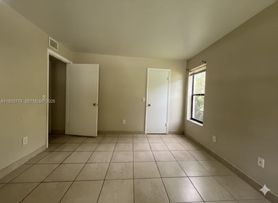 4201 West McNab Road, Unit 15 Pompano Beach, FL 33069 - Photo 16 of 18 a view of a livingroom with an empty space and a window