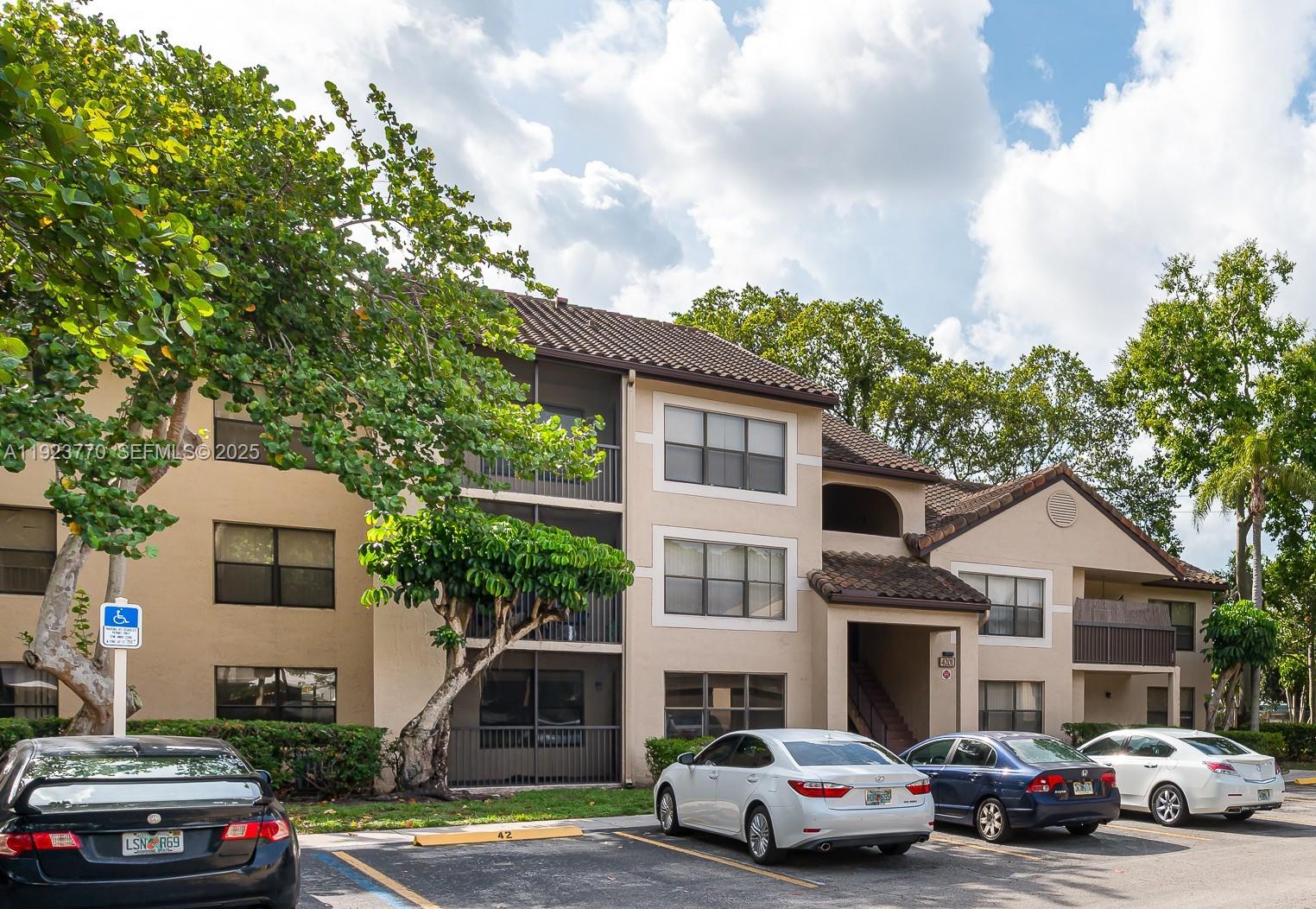 4201 West McNab Road, Unit 15 Pompano Beach, FL 33069 - Photo 4 of 18 a front view of a house with cars parked