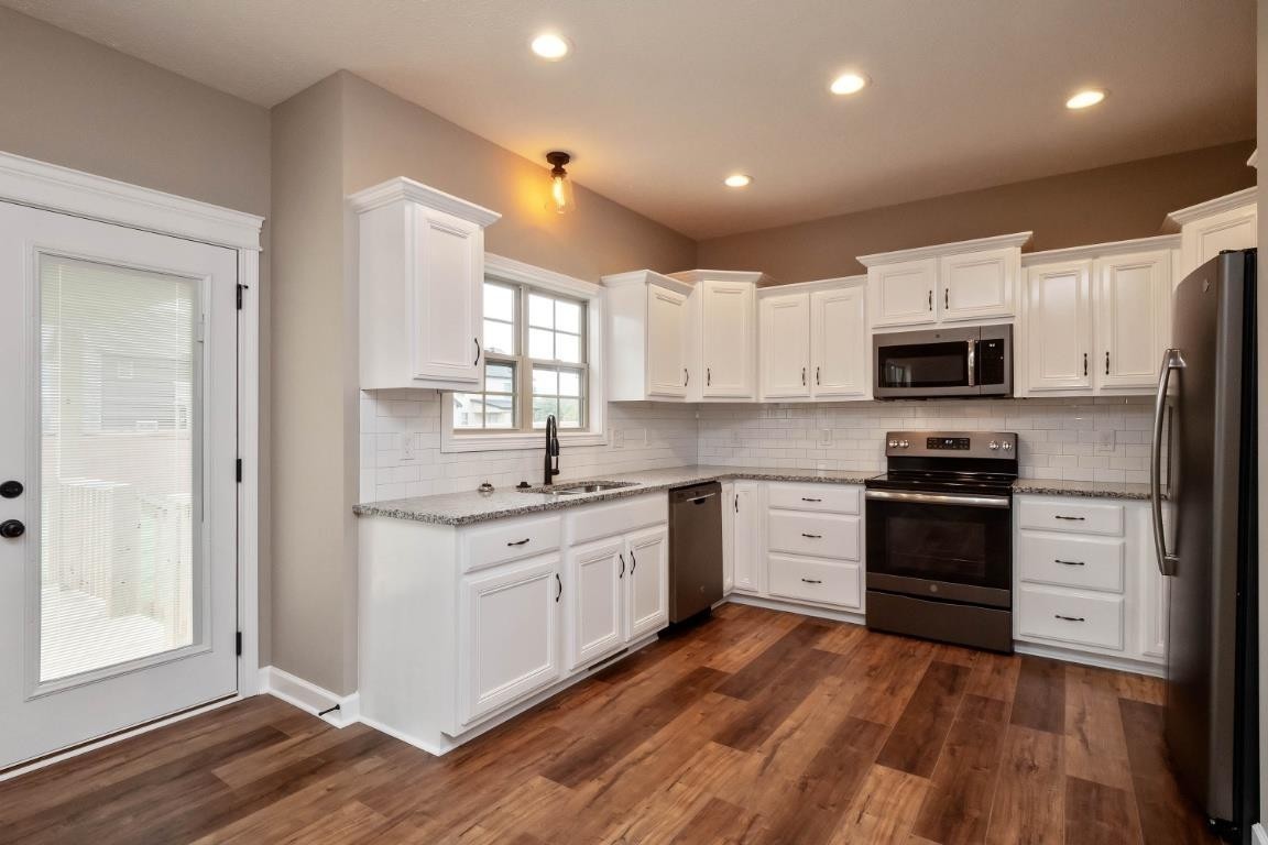 2459 Shadowood Road Clarksville, TN 37043 - Photo 4 of 15 a kitchen with stainless steel appliances granite countertop a stove top oven a sink and a microwave