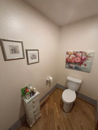 a bathroom with a toilet and a mirror