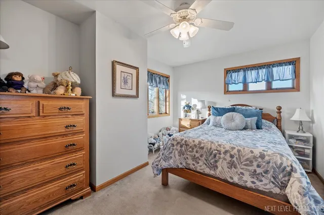 a bedroom with a bed and ceiling fan