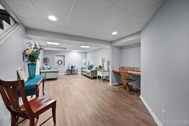 a living room with furniture a fireplace and a potted plant