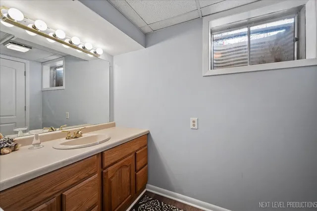 a bathroom with a sink a vanity and a window