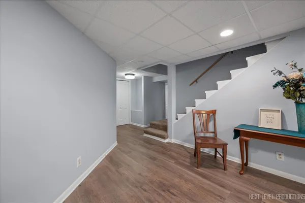 a hallway with chairs and wooden floor