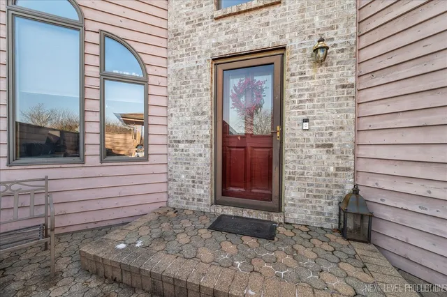 a view of front door of house with stairs