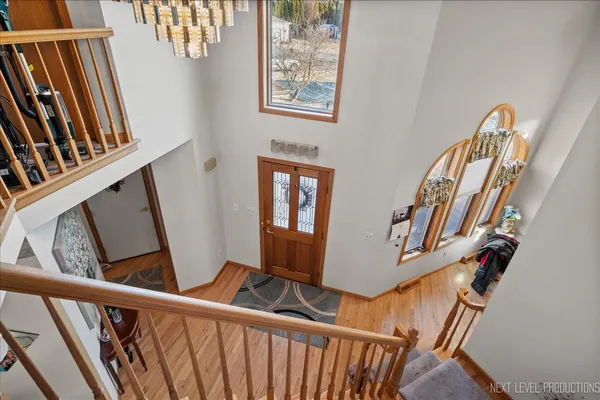 a view of stairs with wooden floor and windows
