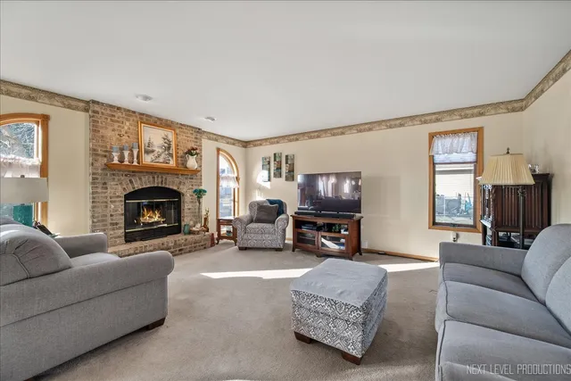 a living room with furniture a fireplace and a flat screen tv