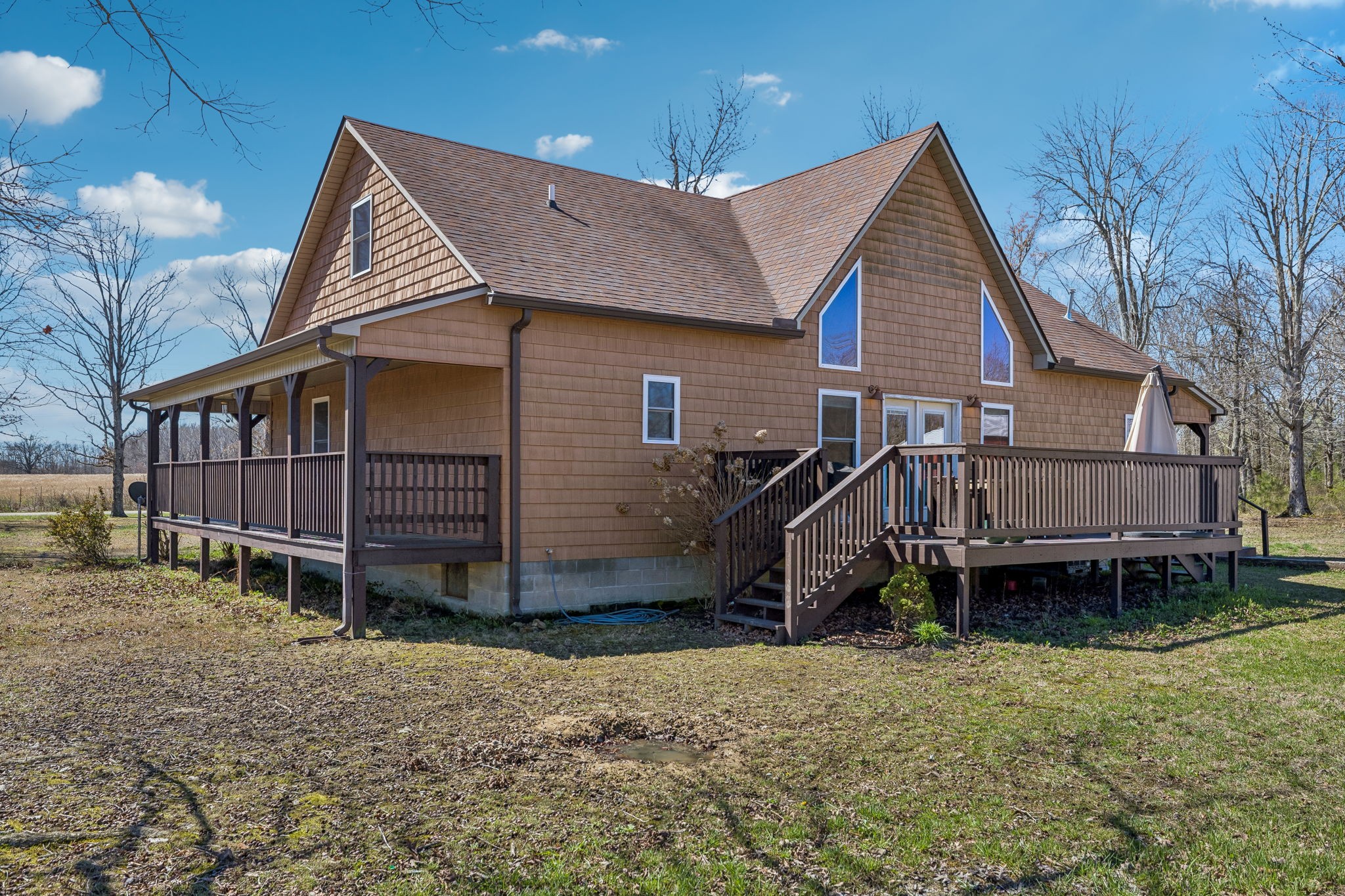 267 Switzerland Road Hohenwald, TN 38462 - Photo 63 of 98 a view of a house with wooden deck and a yard