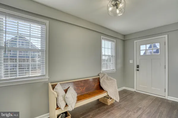 a view of a room with wooden floor and windows