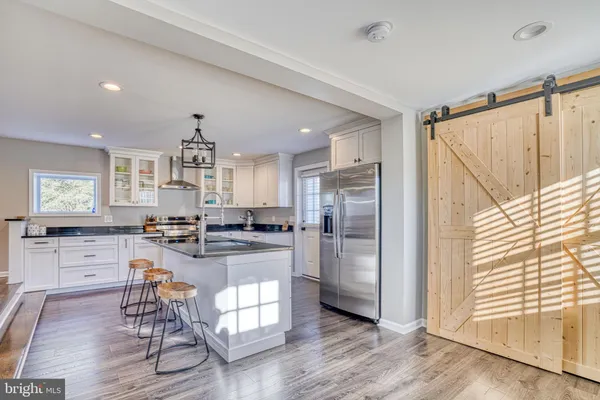 a kitchen with refrigerator and cabinets