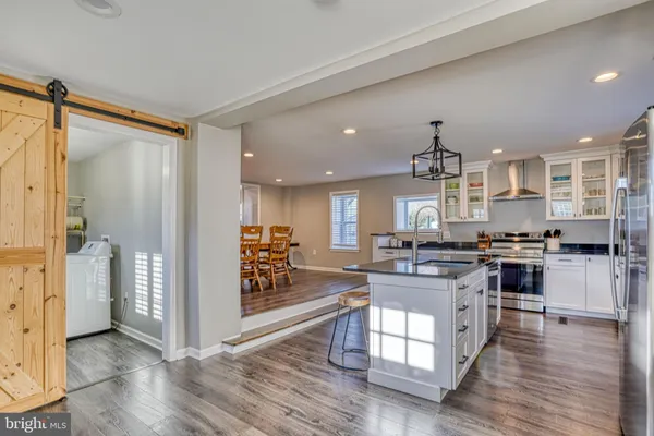 a kitchen with stainless steel appliances granite countertop a stove and a refrigerator