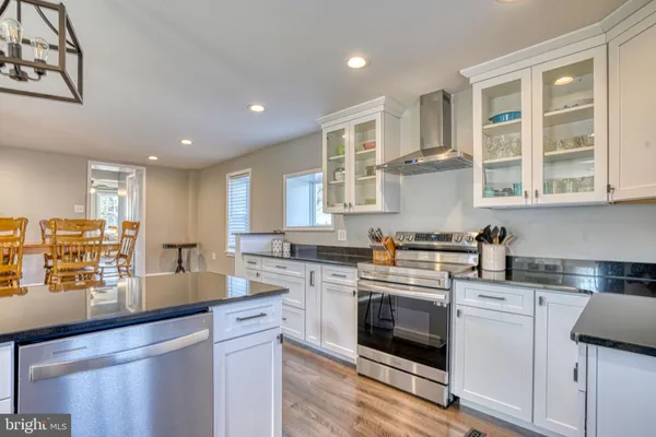 a kitchen with stainless steel appliances granite countertop a stove and a sink