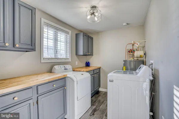 a view of a kitchen with fridge and wooden floor
