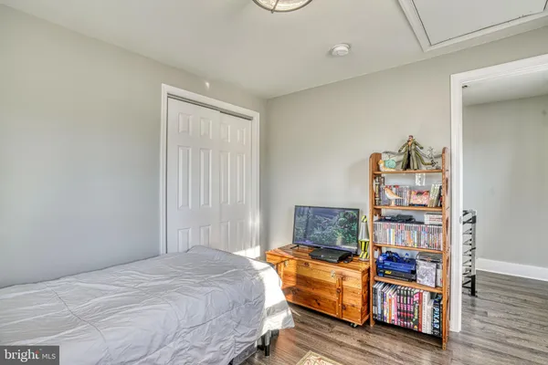 a bedroom with furniture and a book shelf