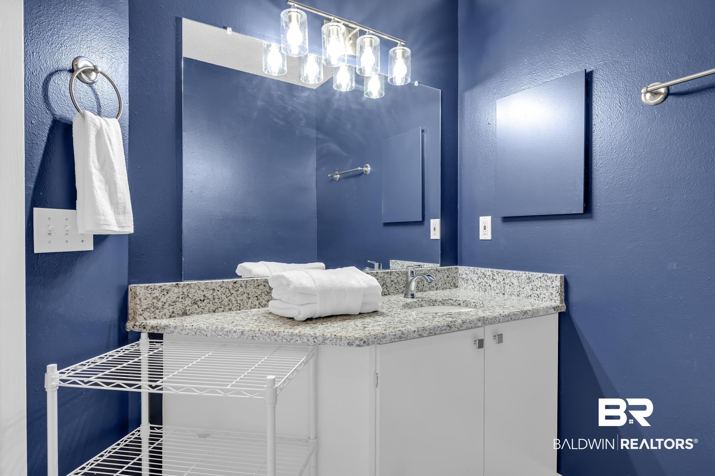 27222 Gulf Road, Unit 33 Orange Beach, AL 36561 - Photo 15 of 29 Bathroom vanity featuring a speckled countertop, undermount sink, and a chrome faucet