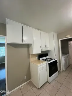a kitchen with a stove and a refrigerator
