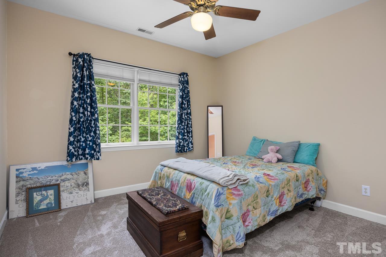 1008 Windstar Way Willow Spring, NC 27592 - Photo 12 of 51 a bedroom with a bed and a chandelier