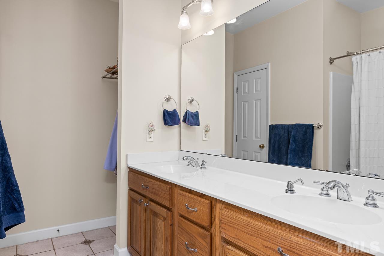 1008 Windstar Way Willow Spring, NC 27592 - Photo 13 of 51 a bathroom with a sink and a mirror