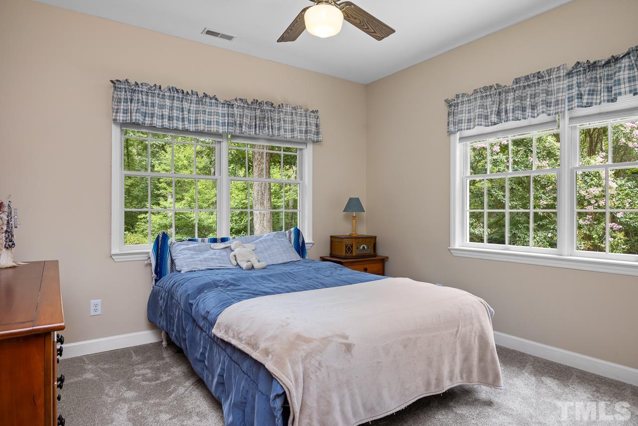 1008 Windstar Way Willow Spring, NC 27592 - Photo 14 of 51 a bedroom with a bed and a large window