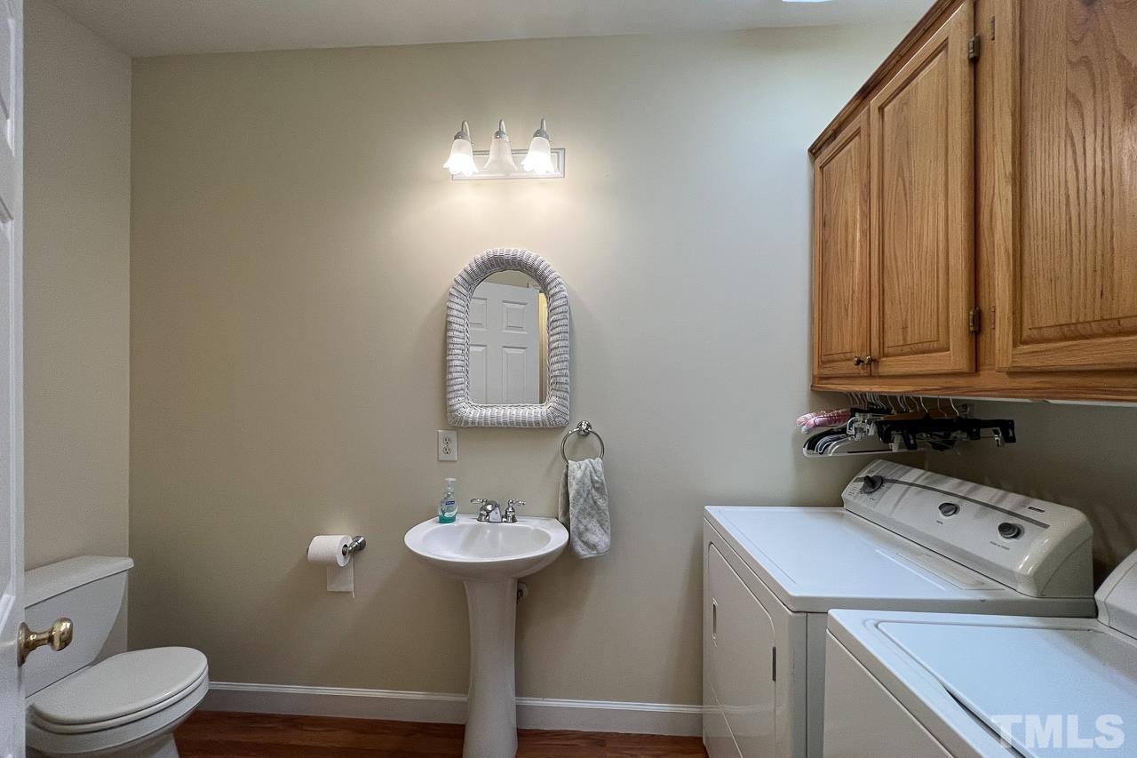 1008 Windstar Way Willow Spring, NC 27592 - Photo 15 of 51 a bathroom with a sink a toilet and mirror