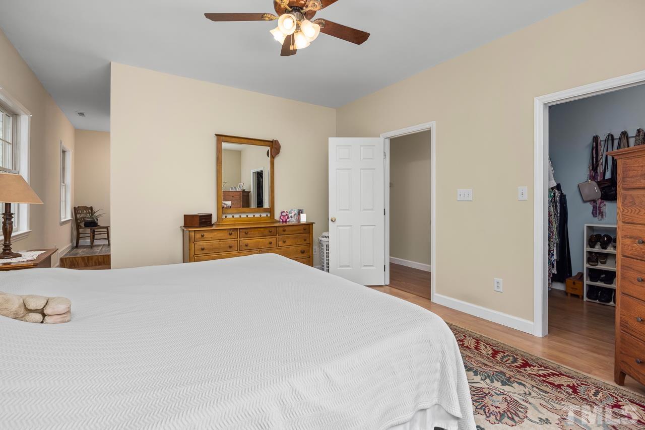 1008 Windstar Way Willow Spring, NC 27592 - Photo 18 of 51 a bedroom with a bed and wooden floor